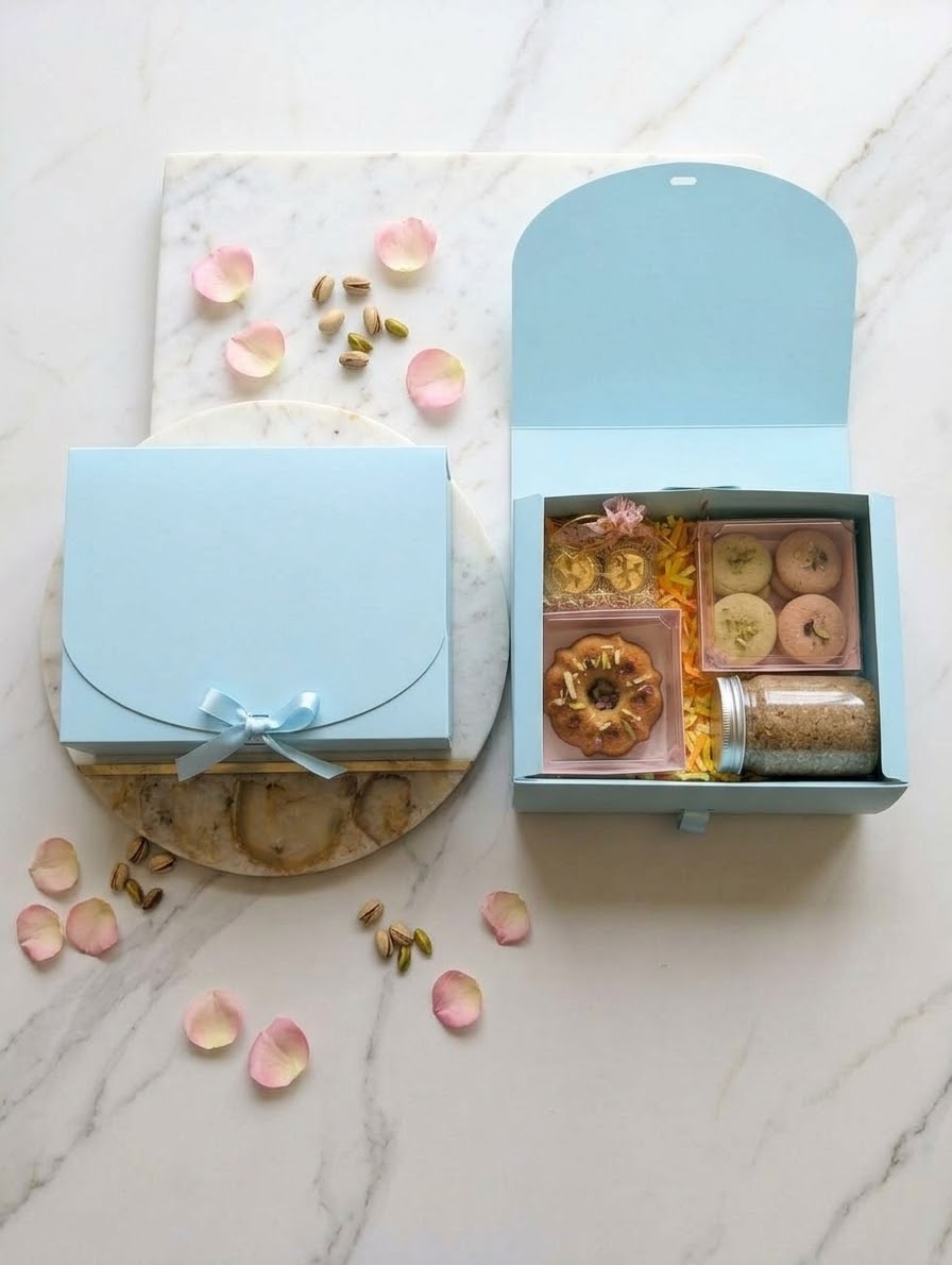 Blue Diwali gift hamper box with cake, cookies, panjeeri and diyas