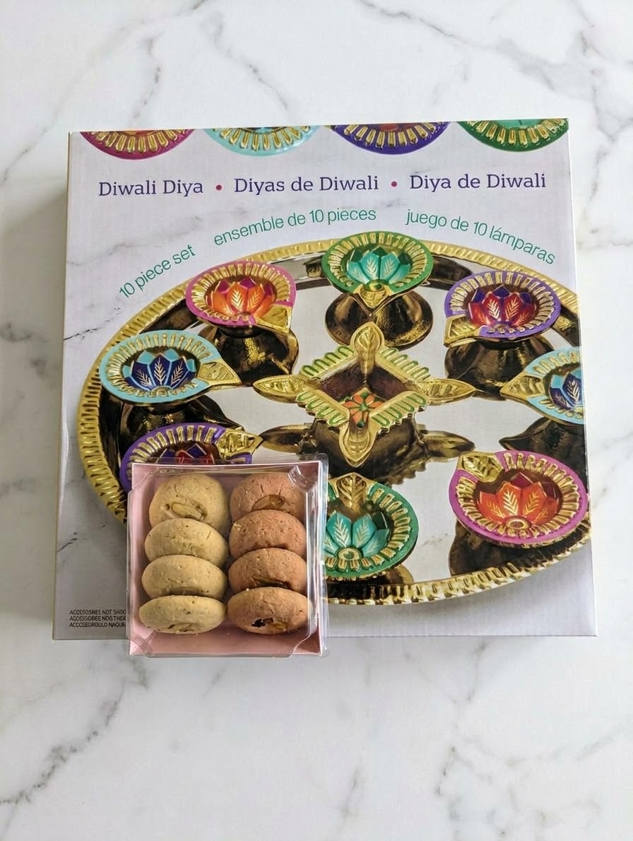 Ten piece Diwali diya gift set with a box of cookies